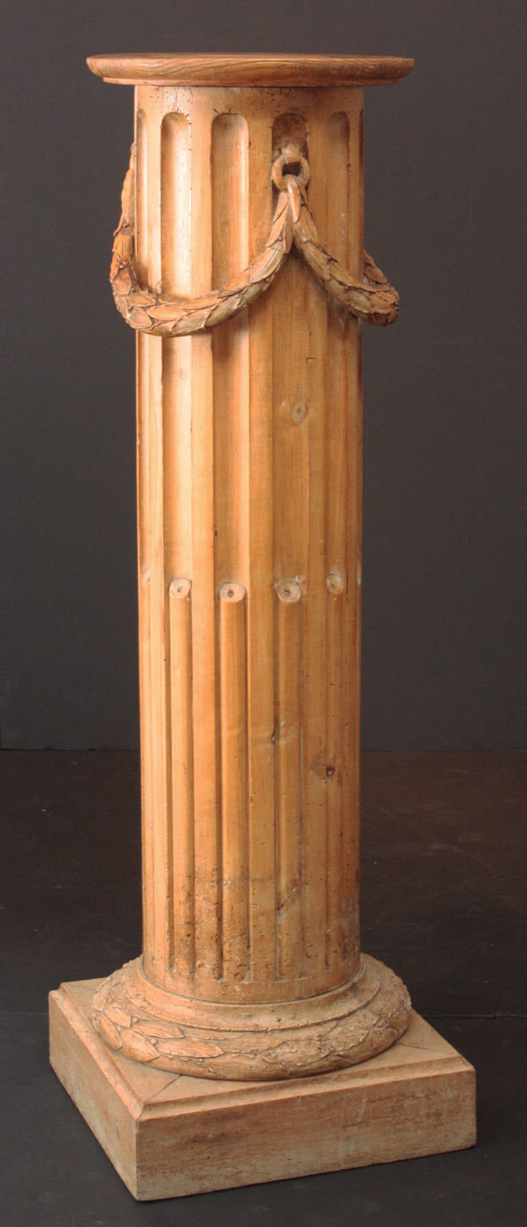 a large Georgian Revival fruit wood fluted pedestal with carved swags of laurel leaves and a laurel wreath base

base is 16.25