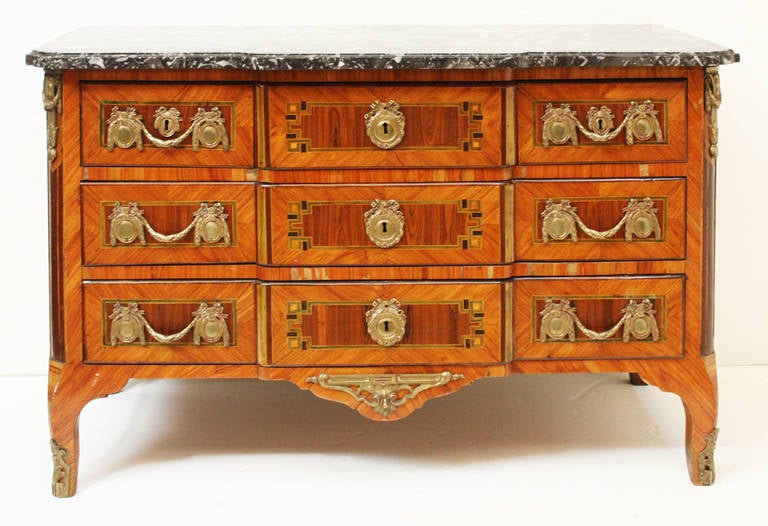 A three drawer transitional block front chest with inlay on drawers. Elaborate ormolu hardware and trim. Black and white marble top.
Stamped B* (see Image 5)