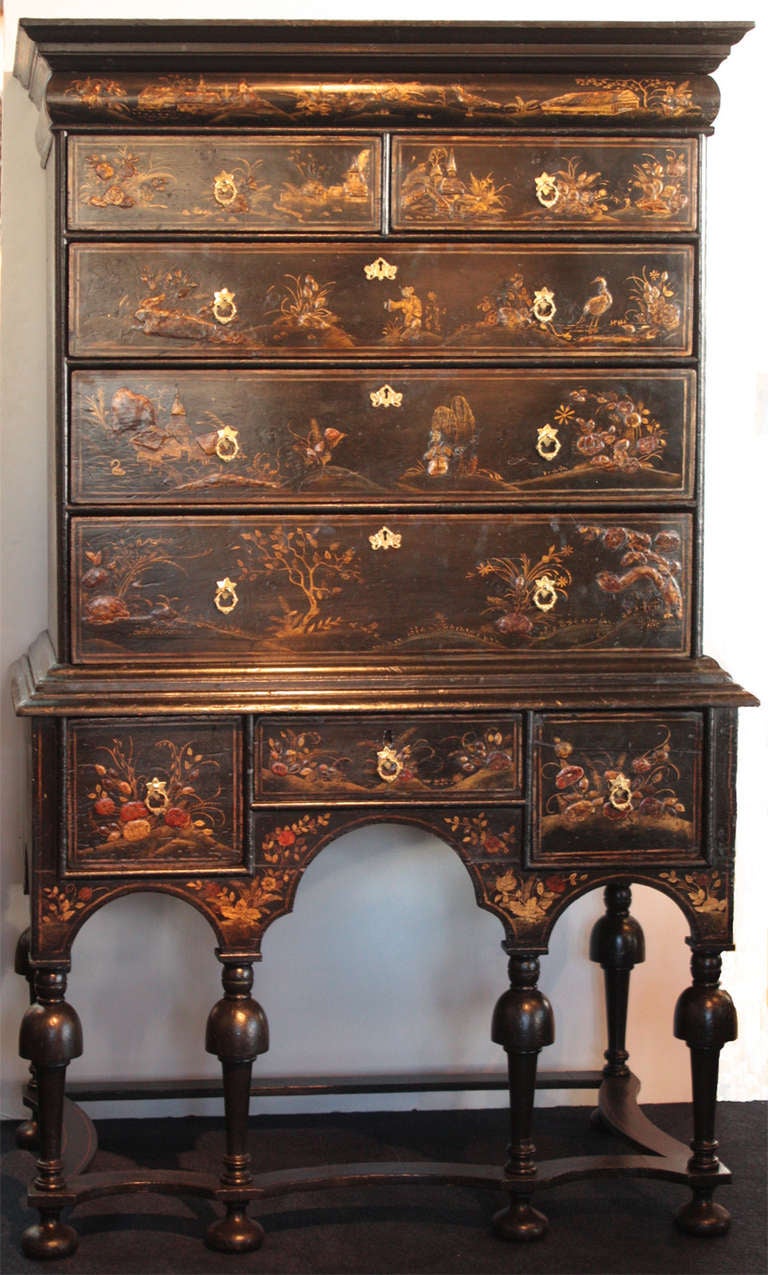 a highboy, William and Mary period, black lacquer and gilt chinoiserie decoration, shallow drawer above two small and three large drawers, stand has additional three drawers on turned legs with shaped stretchers and bun feet