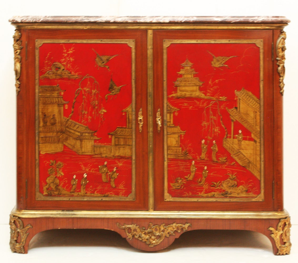 a fruit wood cabinet, transitional style, with red lacquer and gilt Chinoiserie decoration on doors and both sides, interior shelves, ormolu trim on feet, base and upper corners,
Breche Violette marble top  

working key