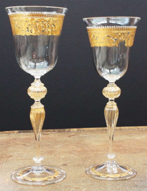 a set of eight Venetian enameled red wine glasses. Gold flecked blown stems and elaborate gold trim. 
9.5
