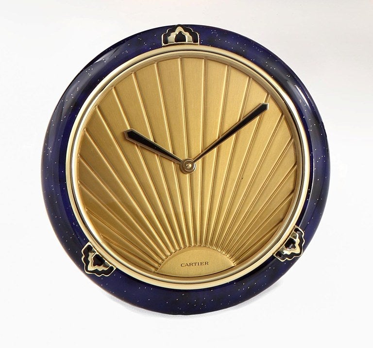 A fine gilded and lapis lazuli enamel mounted desk/alarm clock in the Art Deco style. The clock is unused condition, and in full working order, complete with original fitted Cartier box (paperwork missing). Made in a Limited edition by Cartier in