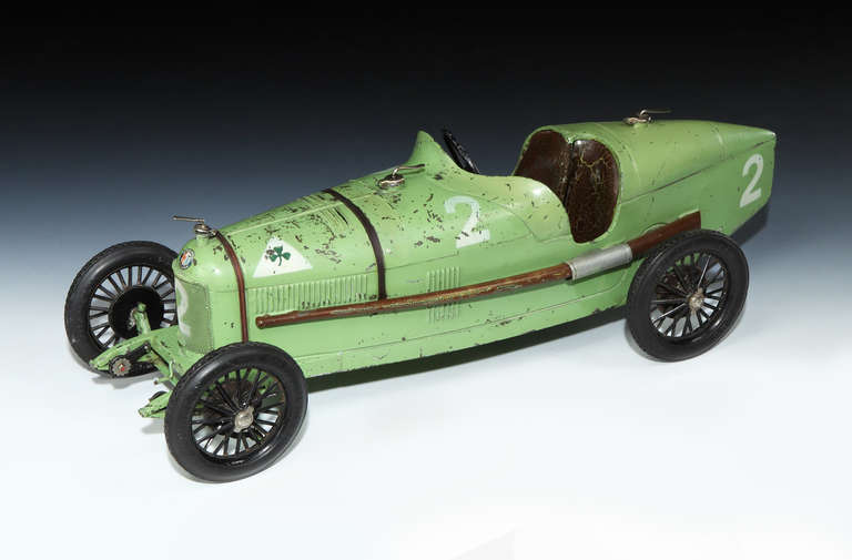 A scarce large size, tin-plate toy of an Alfa Romeo P2 of second series, made by CIJ (Compagnie Industrielle du Jouet) France, circa late 1932.

Finished in green, and numbered 2 in white, with Pneu Michelin treaded tyres.