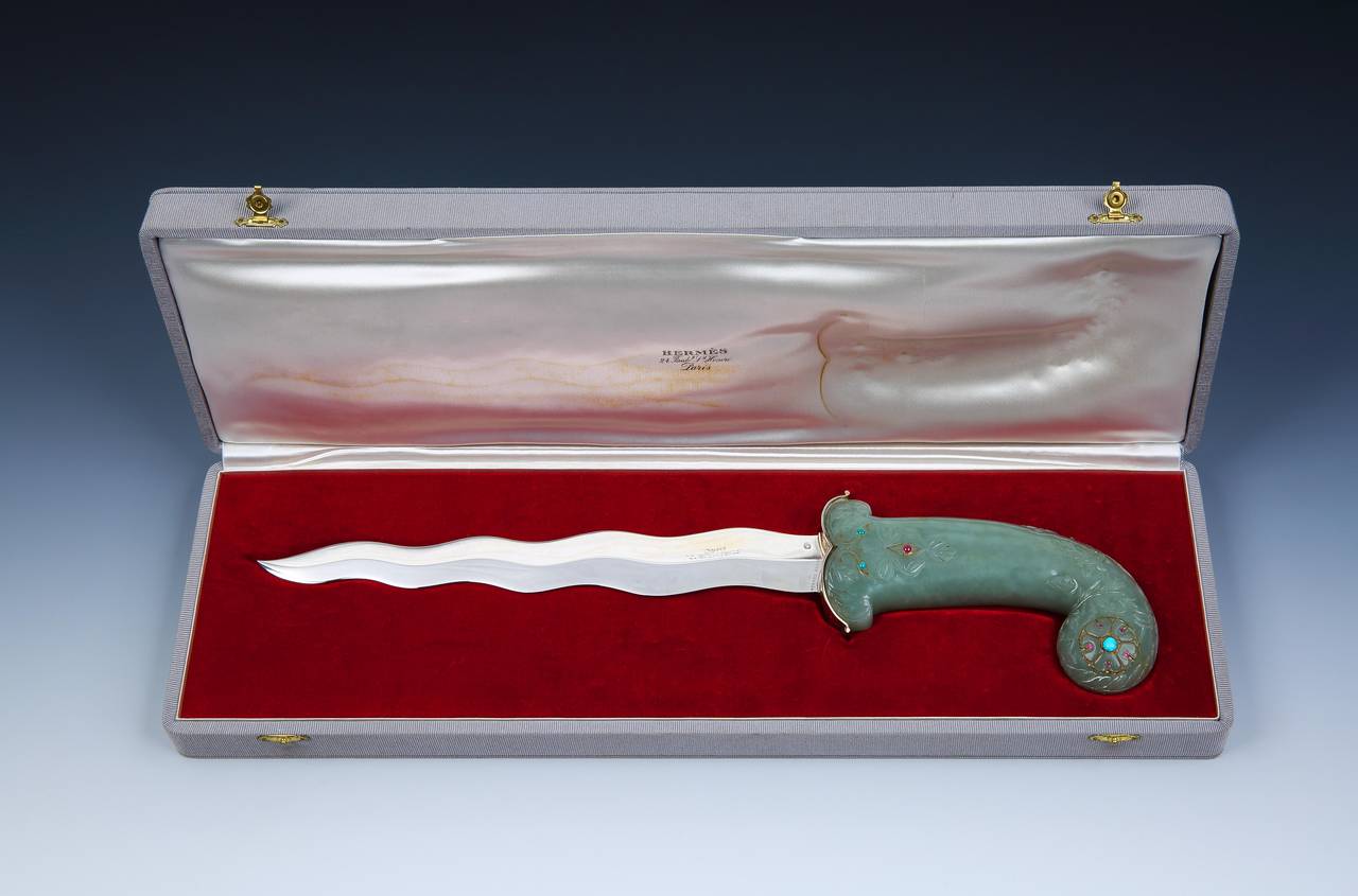 An extraordinary, unique special-commission ceremonial dagger with cast silver kris blade, and bearing poinçon marks and stamped HERMÈS PARIS. 

The hilt, in vermeil (silver gilt) is heavily carved with a foliate pattern terminating in scrolled