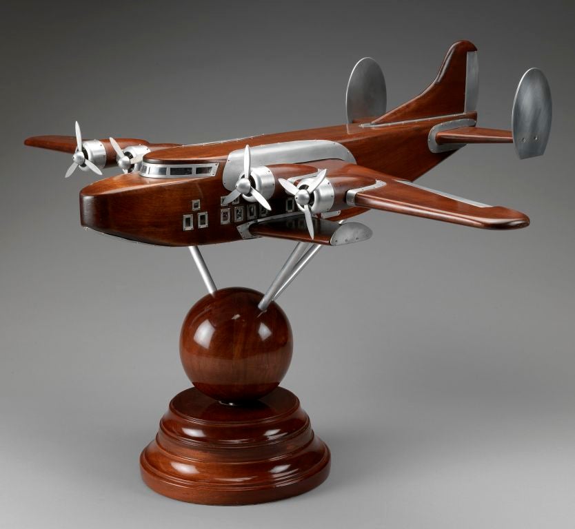 An exceptionally high quality and very stylish 1938 boardroom model of the legendary flying-boat with all aluminium detailing, windows and propellers, the tripod mounted on a rotating polished solid mahogany globe, with swept plinth underneath.