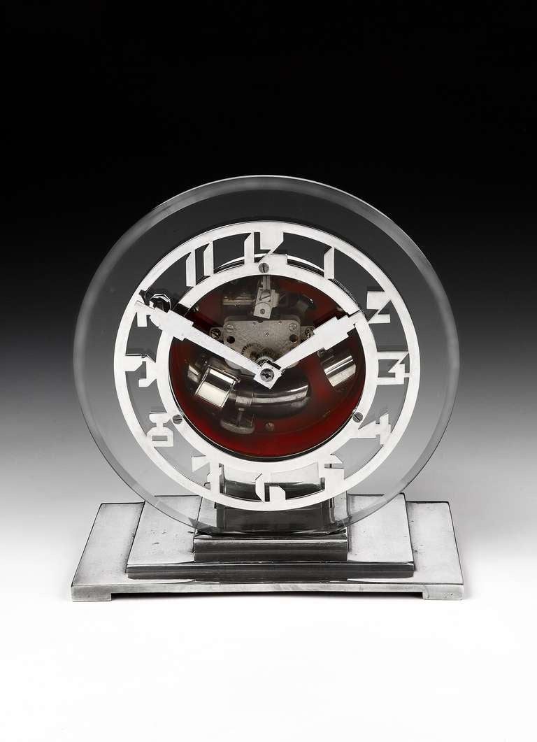 A petite, glass Art Deco mantel clock by ATO. French, circa 1930s, with a glass face with silvered numerals, and stepped, metal plinth.

The Company's founder, Leon Hatot (ATO is the diminutive of his surname) patented prototypes of the