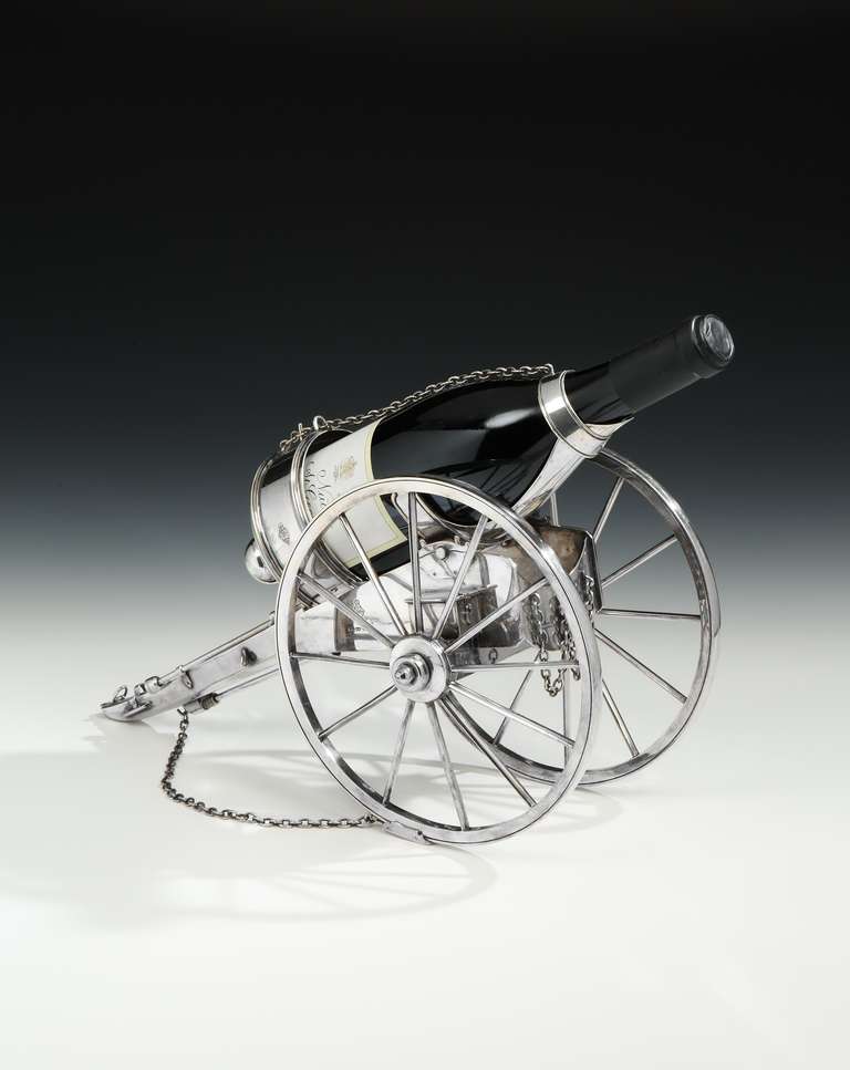 A novelty bottle holder by Atkin Brothers of Sheffield, in the form of a field gun, with design registration marks for 1868, the ‘gun’ created by the bottle when in position. The carriage finely detailed with bottle-collar secured with a chain to