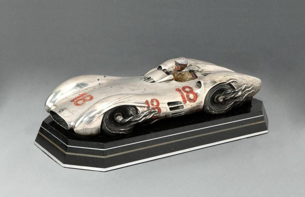 ‘Quicksilver (Fangio)’ a finely detailed, hand painted solid Sterling silver sculpture depicting Juan Manuel Fangio in his W196 Mercedes #18. Signed and dated 1988. Edition of 10, marked 4/10 A/C. The whole mounted on a marble base.