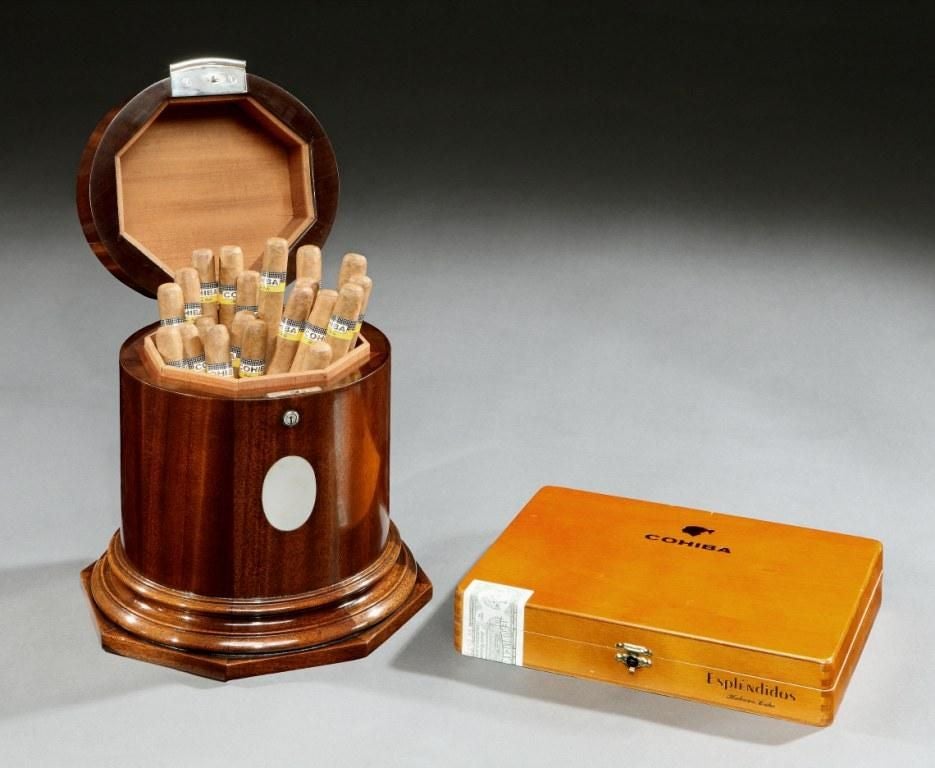 A superb cigar ‘drum’ humidor of circular form, with vacant oval cartouche to the front, with lock and key, the hinged lid with applied silvered bronze Royal crest, the facetted interior capable of storing up to 50 cigars.