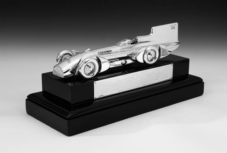 A highly important and unique, special commission Sterling silver model of ‘Blue Bird,’ the 1931 land speed record- setting car driven by Sir Malcolm Campbell. Finely detailed and bearing an engraved Union Jack and Napier Campbell to the tail, the