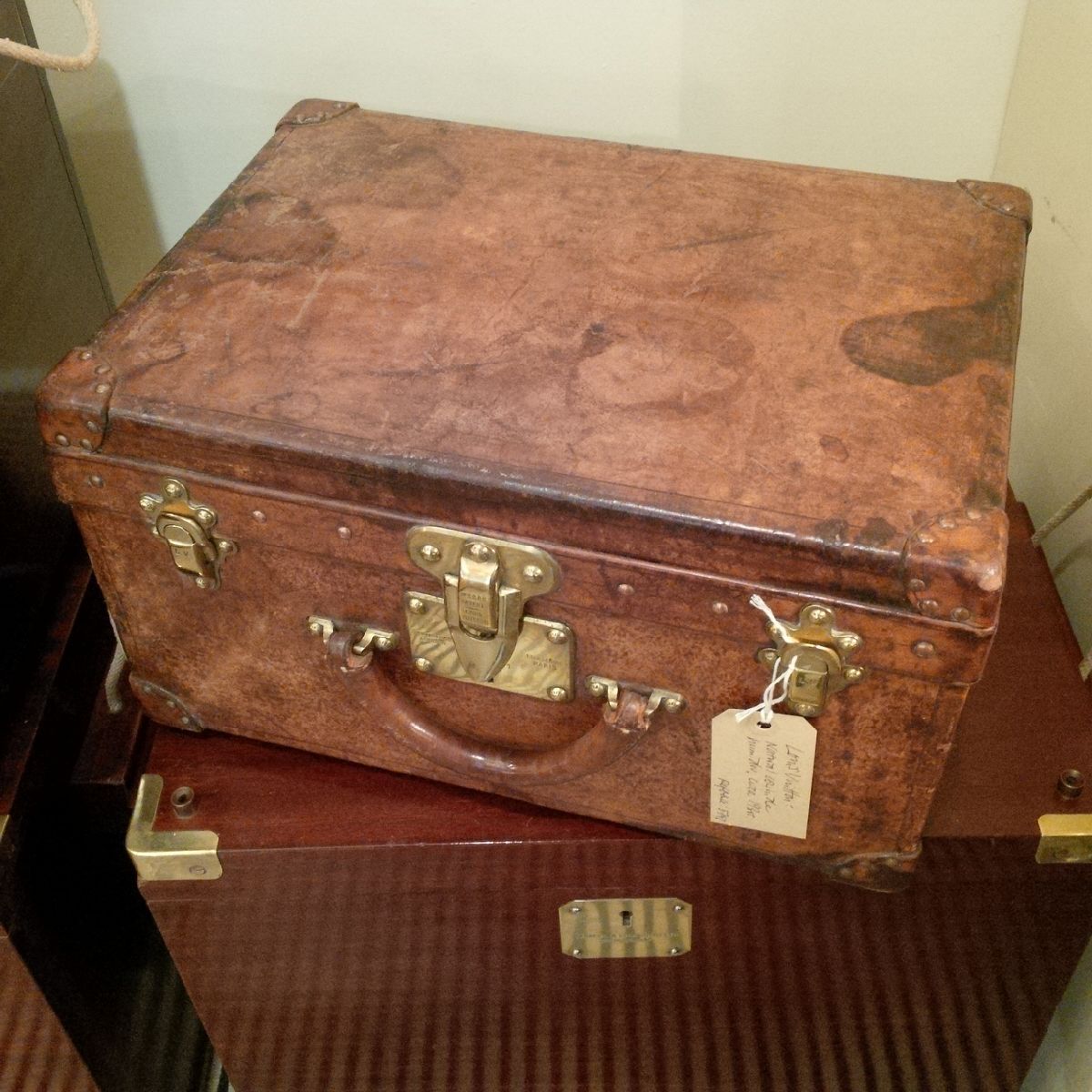 A rare small travelling trunk in natural leather by Louis Vuitton, with leather corners with brass studs, lock and latches and original leather handle to the front. The interior has been newly fitted as a two-layered humidor, with double-width