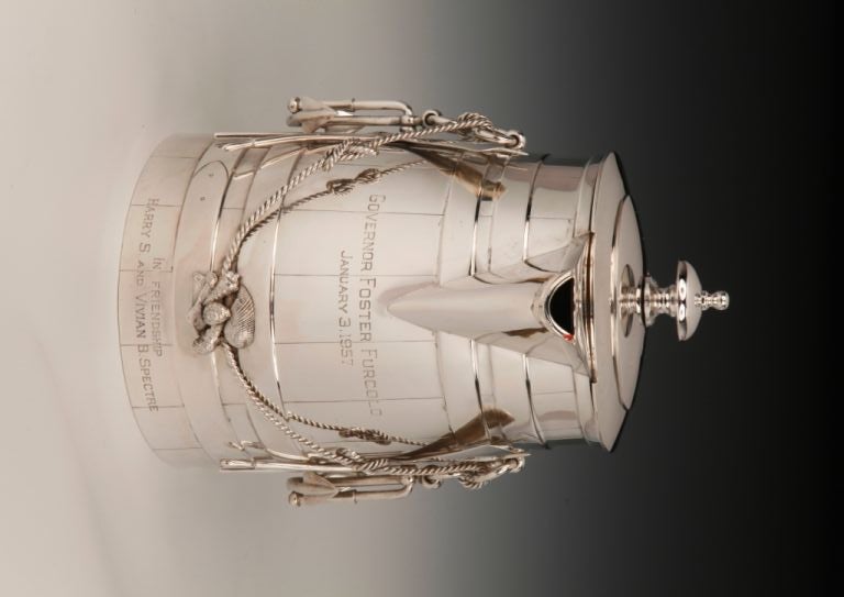 A magnificent and unique, Sterling silver flagon of maritime interest, the main body of ‘barrel’ form,  the front and sides with applied naval motifs, and seashells with a handle of ‘rope’ form, and a plain finial to the lid.  Inscribed ‘Governor