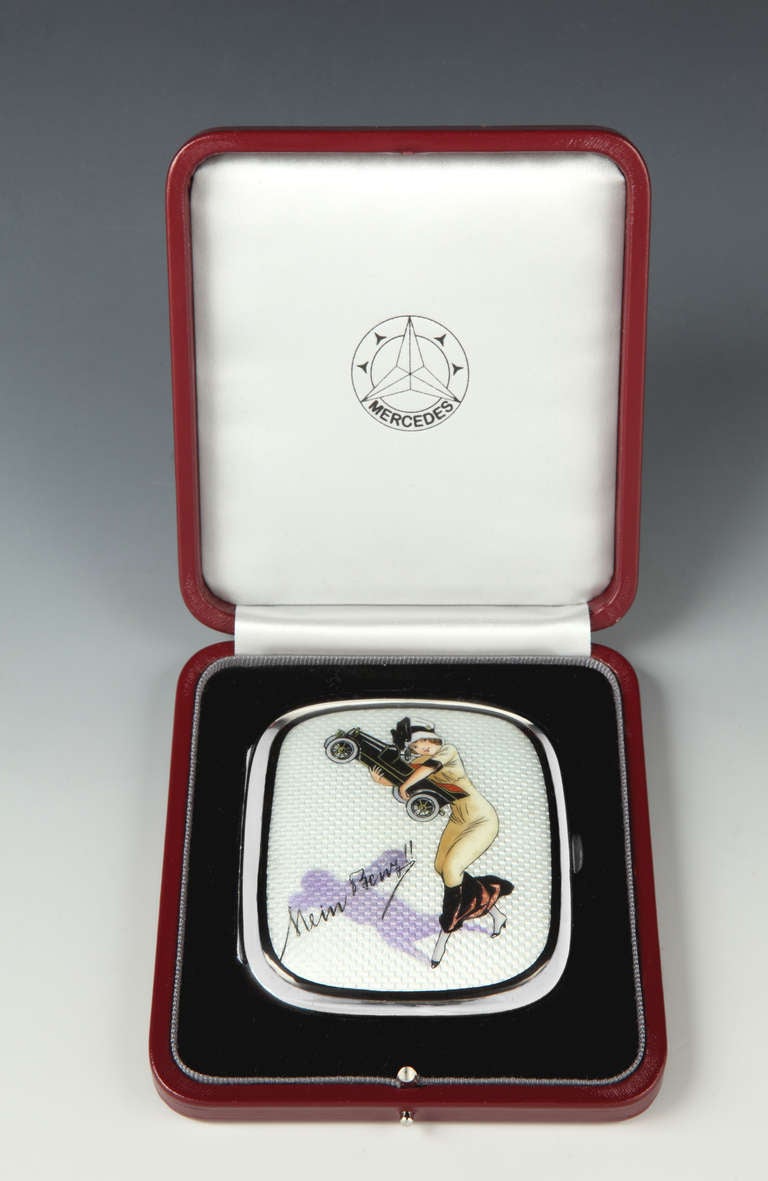 A very rare German silver and guilloche enamel cigarette case depicting a stylishly dressed young lady embracing her 'Benz', with cabouchon push-button and gilded interior and set within a bespoke blind-embossed leather Mercedes-Benz presentation