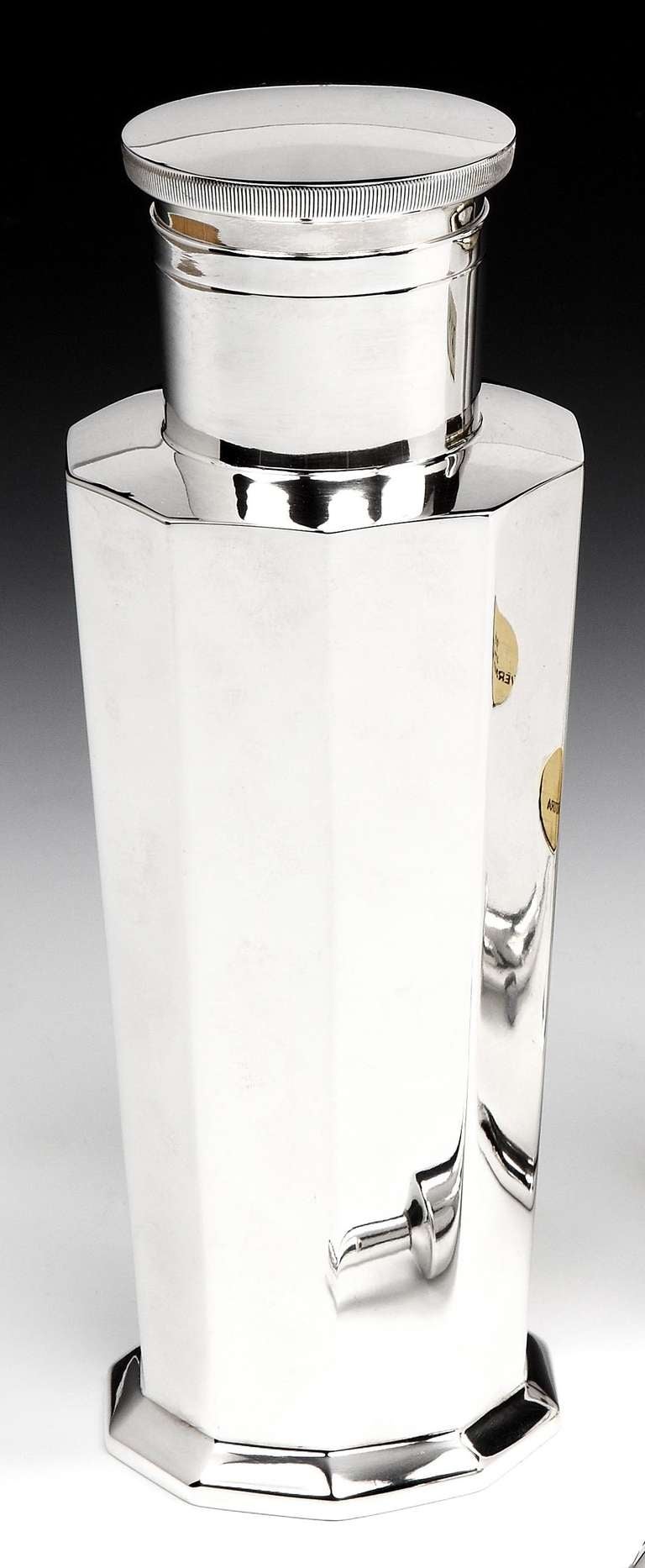 An incredibly stylish Art Deco silver plated cocktail shaker, designed by Keith Murray for Mappin & Webb, in the Modernist style with a knurled cap serving as a double measure or jigger, and removable strainer. Marked to the base 'Mappin & Webb,