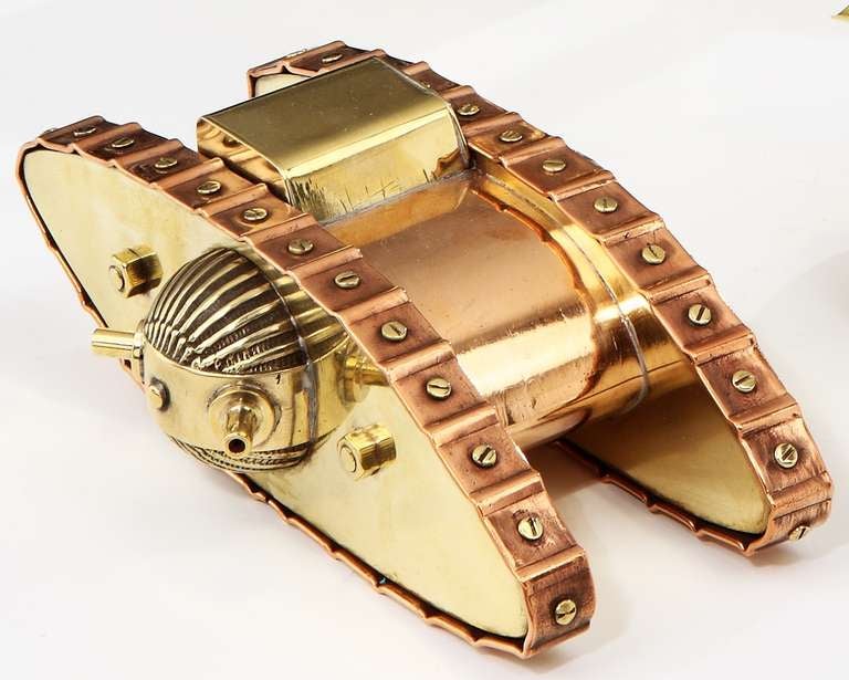 A finely made 'Trench Art' model of a Great War tank, completely constructed from found and salvaged materials, in highly polished brass and copper, with stylised detailing for the caterpillar tracks, side mounted cannons, and turret.

'Trench