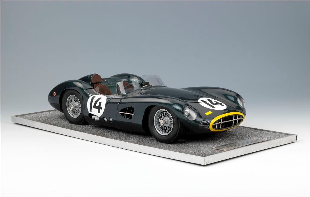 An imposing model of the Aston Martin DBR1, as driven to victory by Tony Brooks and Noel Cunningham-Reid in the 1957 Nurburgring 1000 kms race, a detailed kerbside model with full cockpit detailing and upholstered seats, mounted on a textured