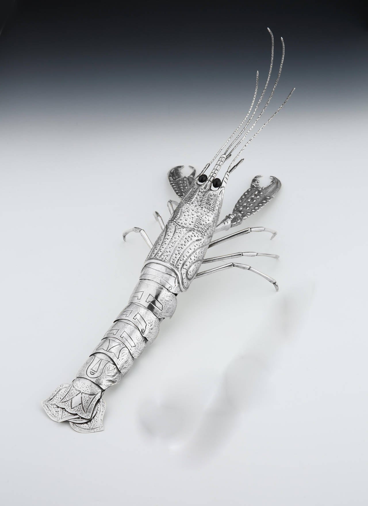 Armando da Silva Ferreira of Oporto, Portugal: a beautifully made silver centrepiece in the form of a lobster, with fully articulated pincers and legs, and onyx-black glass eyes and fanned tail. Although stylized in form, the lifelike movement has