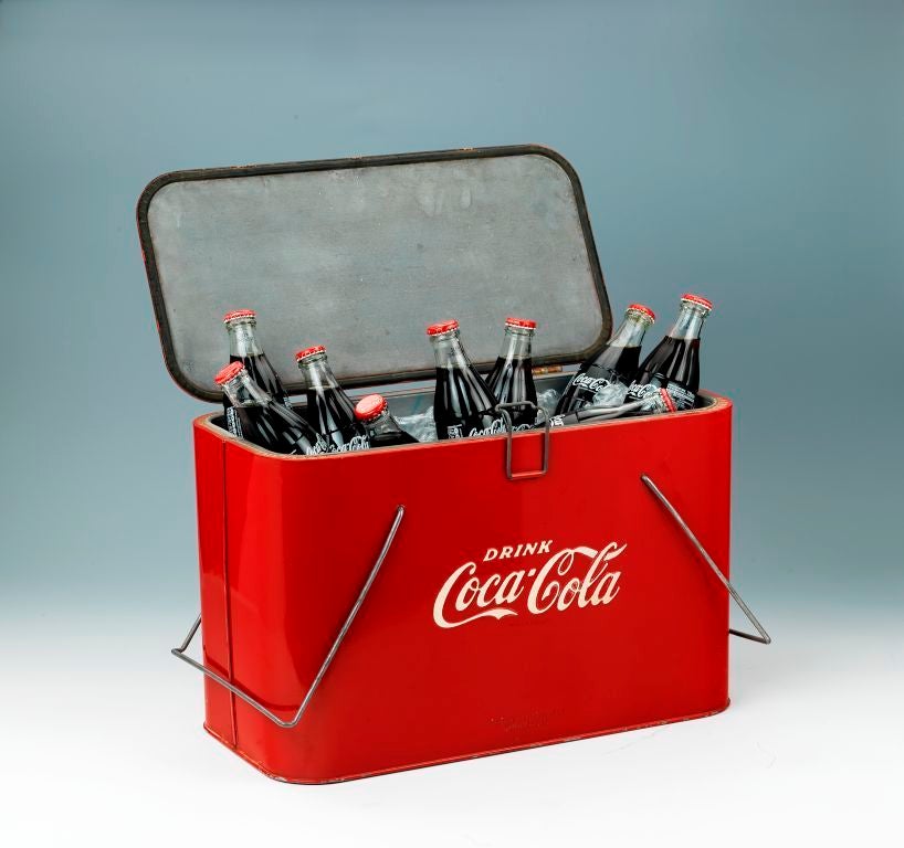 A promotional picnic cooler made by the Coca Cola Company.<br />
<br />
Hinged at the rear with a small wire latch and two wire handels. To the base marked Progress Refrigerator Co. Louisville Ky. American.