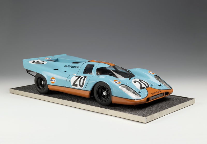 An imposing 1:8 scale model of the Porsche 917, chassis #917-043, in blue and orange 'Gulf' livery, a detailed kerbside model with full cockpit detailing and upholstered seats, mounted on a textured plinth, the car known for it's Le Mans 24 Hour