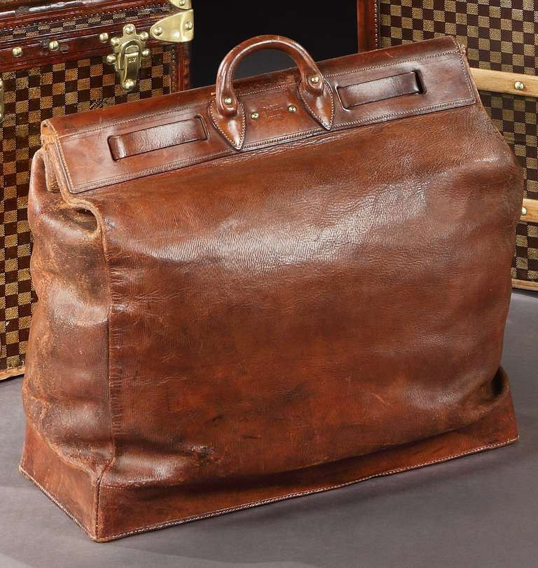 A very rare all-leather ‘steamer’ bag, with leather base, and through strap. French, circa 1910.