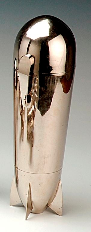 An extremely rare, possibly unique ‘Zeppelin’ cocktail shaker set of massive proportions, the main body acting as the cocktail shaker, the gilt-lined nose-cone removes to reveal a shaker with integral strainer/juicer and cap and containing two large