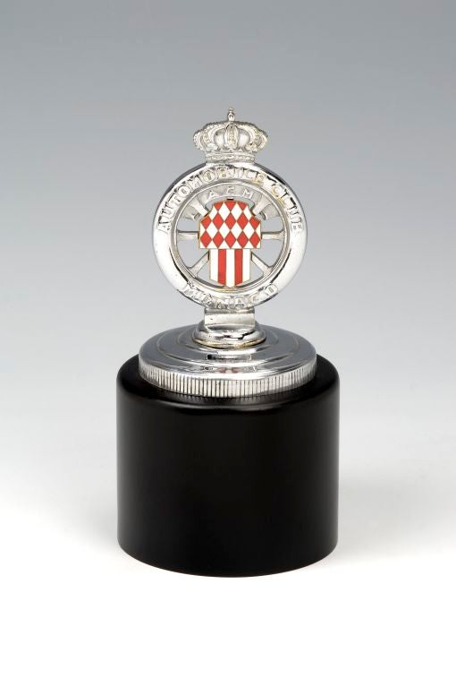 A rare and unusual Monaco Automobile Club (ACM) chrome plated car mascot. Mounted on a spun metal, black lacquered base.