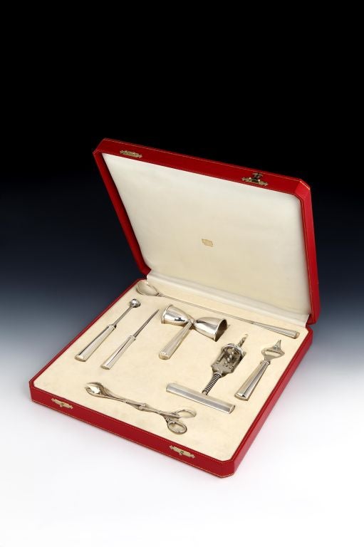 A magnificent and very impressive Sterling silver 7-piece bar set. Comprising of ice tongs, longhandled mixing spoon, ice pick, corkscrew, bottle opener, ice-crusher and double-jigger (single and double measures), all signed Cartier and marked