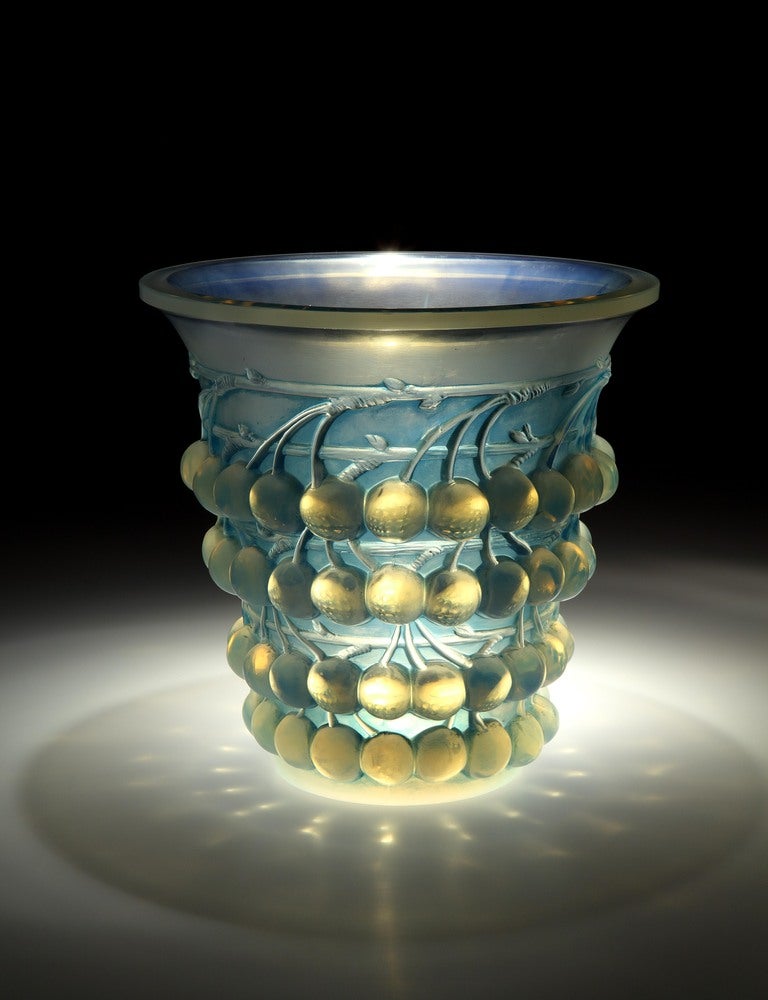 A rare 1930 opalescent vase of tapering form, the exterior profusely moulded in relief with bands of cherries. In excellent original condition especially rare in opalescent glass and with original blue patina. Diameter at the widest point: 8
