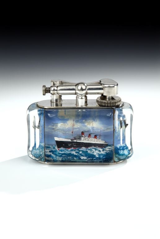 An extremely rare silver-plated 'Aquarium' table lighter, the perspex body enclosing hand-painted scenes of the Queen Mary at sea, the side panels featuring seagulls in flight, with silver plated lift-arm marked DUNHILL, in excellent condition and