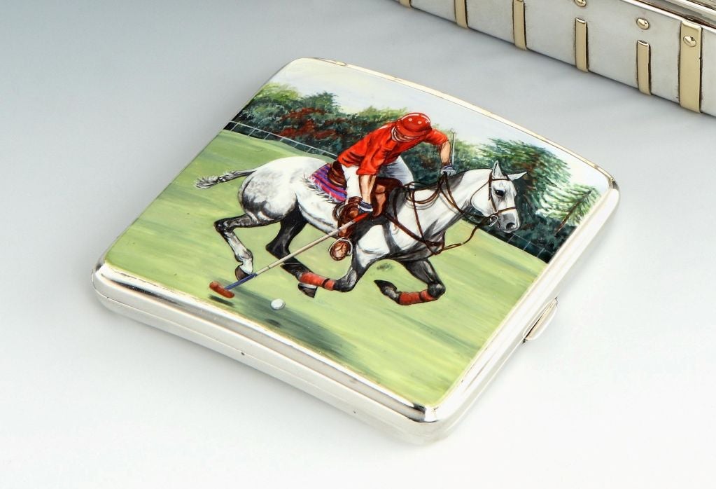 A fine Sterling silver cigarette case, featuring a well painted scene to the front in enamel of a polo player addressing the ball from his horse, the plain case with gilded interior bearing hallmarks, maker’s marks and date marks for Birmingham 1929.