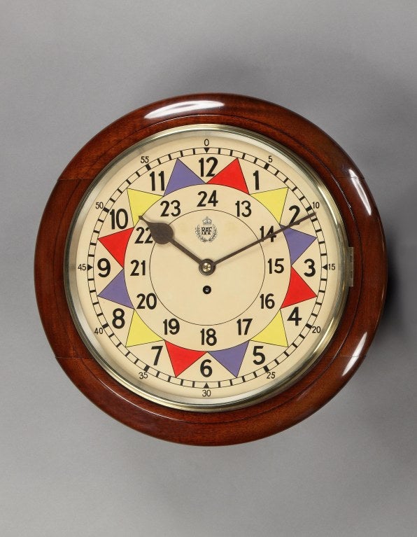 Operations Room ‘Sector’ clock by F.W.Ellott Ltd for the Royal Air Force. A superbly restored and extremely rare R.A.F. Operations Room sector clock with ribbed hands, red, yellow and blue five-minute markings and Service crest, the mahogany case