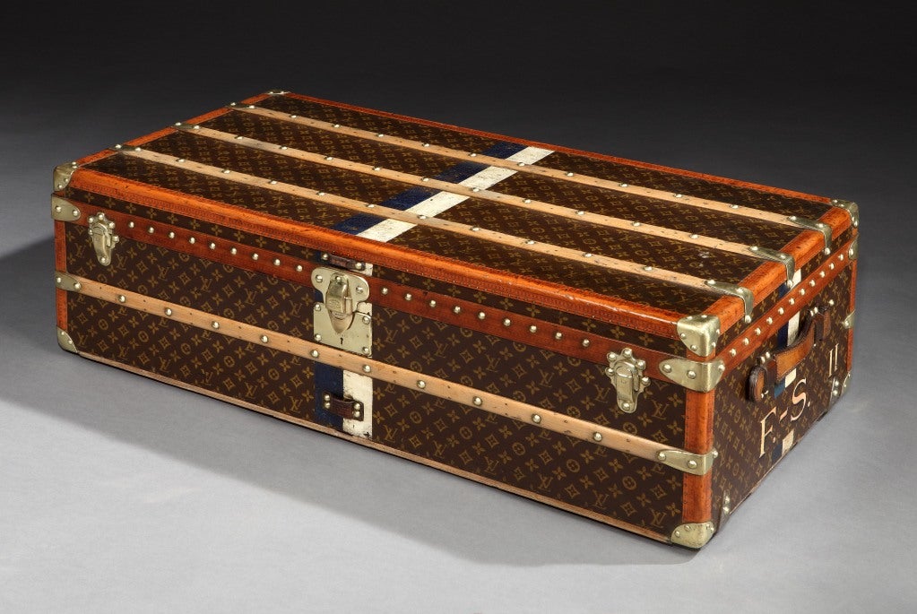 A fine, Monogramme patterned canvas, leather and all-brass trimmed Malle Cabine (cabin trunk), with leather handles, brass locks and studs, and white and blue identification stripes, bearing monogram F.-S. II in white to each end, in remarkable,