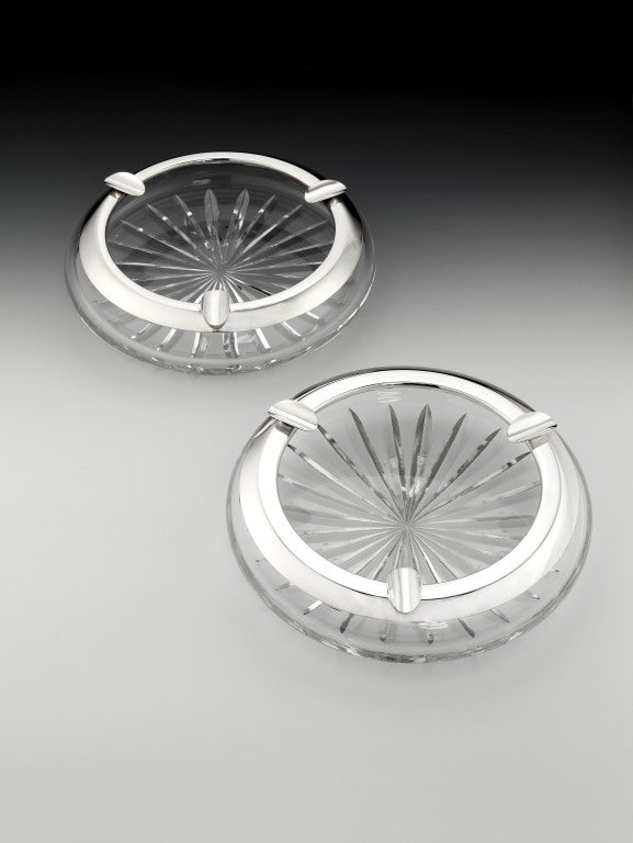 A pair of massive, Sterling silver mounted, crystal Art Deco ‘Billiard Room’ cigar ashtrays with diamond cutting to the bases, each of the silver mounts with three cigar rests.