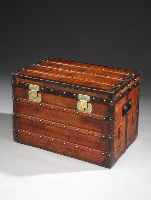A very early packing case or trunk by Louis Vuitton, with iron trim, wooden slats, brass studs and locks, and iron handles, dating from when Vuitton were a company of packing case makers, prior to becoming Malletiers (trunk makers), with striped