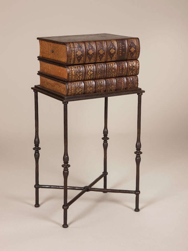 A pair of mid-20th century French occasional tables in the form of books mounted on metal stands.