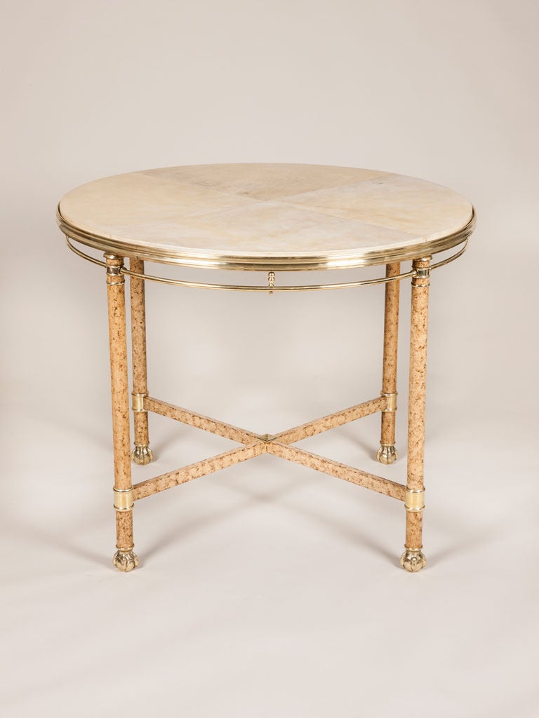 A mid 20th century brass mounted gueridon with a leather lined top, by Maison Jansen, c.1950.