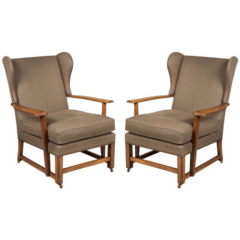 A Pair Of 1930s Oak Framed Cotswold School Wing Armchairs at 1stDibs