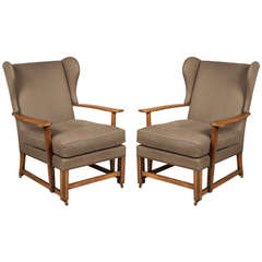 A Pair Of 1930s Oak Framed Cotswold School Wing Armchairs