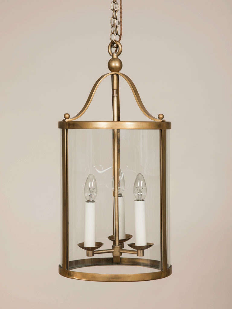 A cylindrical patinated brass lantern with glazed sides and simple mounts, French circa 1940.