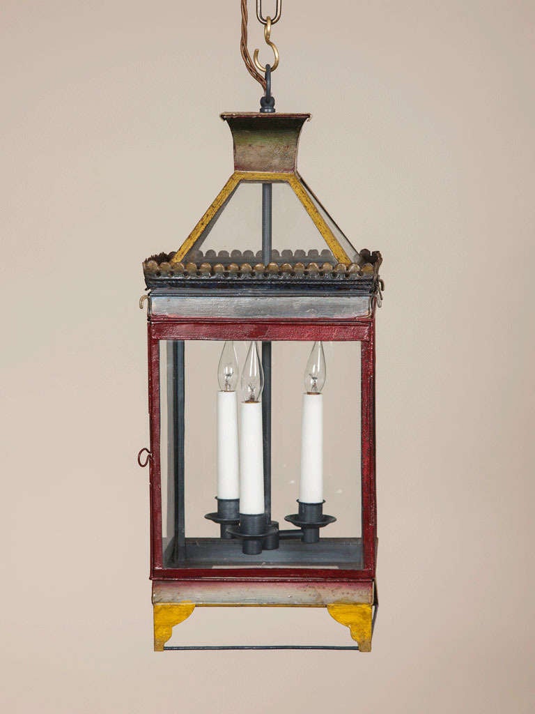 A pair of 19th century square painted tole lanterns with polychrome decoration, wired for electricity.