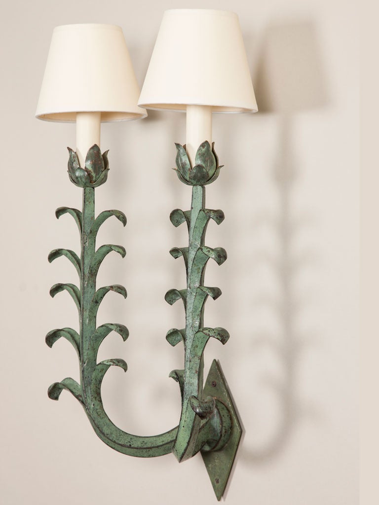 A pair of 1940s French tole two-branch wall lights with a simple sprouting leaf design.