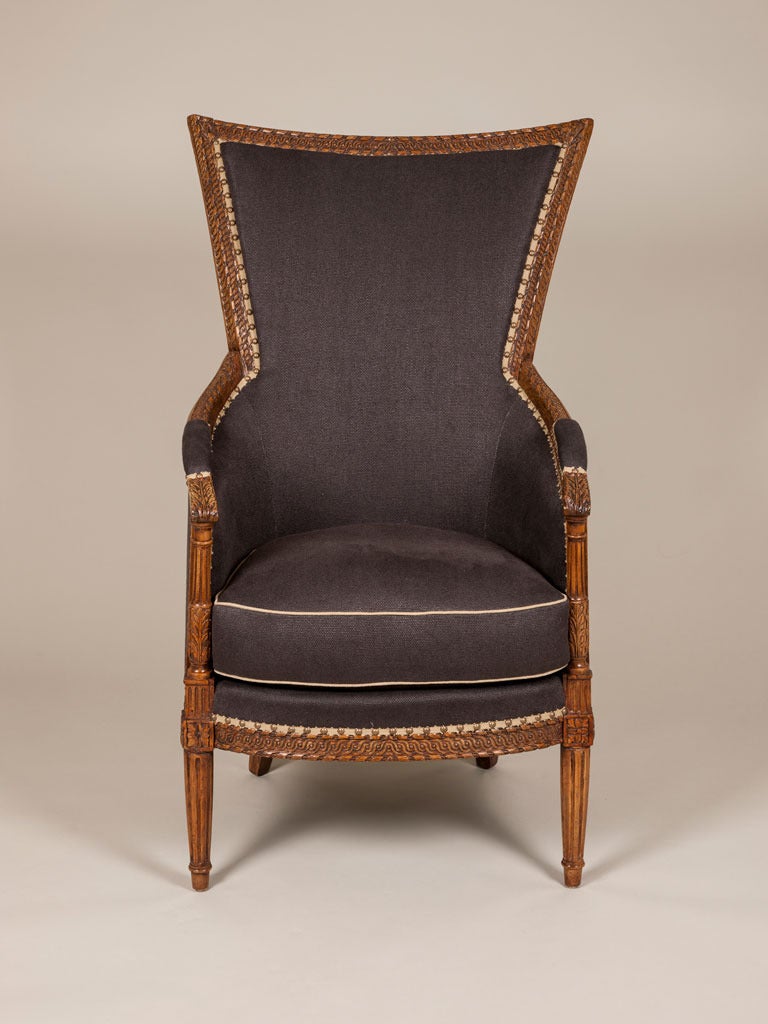 A Directoire period French bergere with a tall, flared racked back and carved frame, circa 1800.