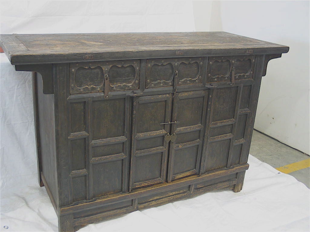 Original patina. Elm Wood construction. Three drawers and a pair of doors with access to a very generous storage area.