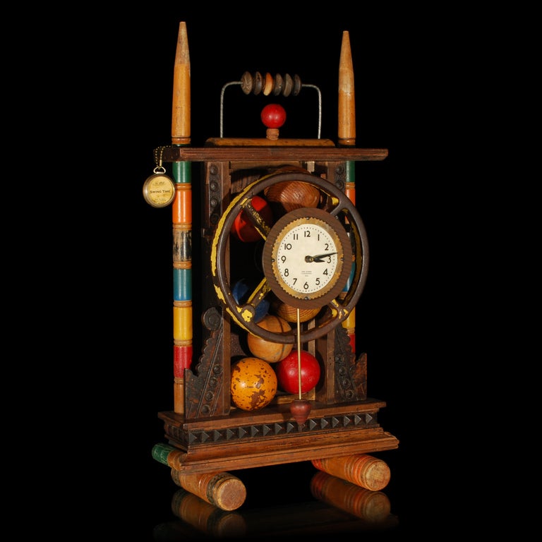 This wonderful Folk Art looking clock was made by Jon and Lisa Van Dusen and is made from a variety of vintage pieces. Titled Swing Time this unique clockwork art piece with its working pendulum would make a statement in any room.

All the pieces