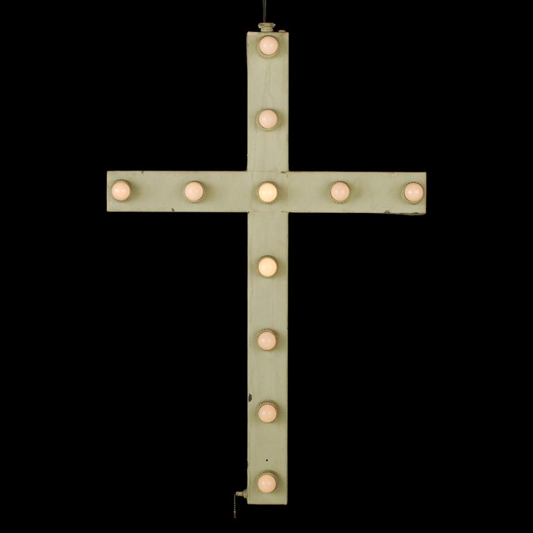 This is a great antique Church Cross with 11 light bulbs lighting the front. The cross is made of metal and most likely spent its whole life indoors. It's in very nice condition and appears to have been repainted a few times. The lighting appears to