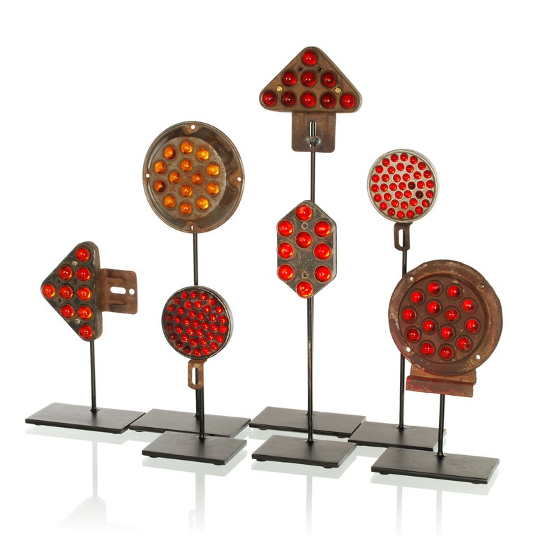 This is a great collection of 7 antique Reflectors from the early 1900's, all mounted on custom made steel stands. Once found on old trucks, trains and tractors, these marble reflectors are now collectible. Each of the reflectors is made of steel