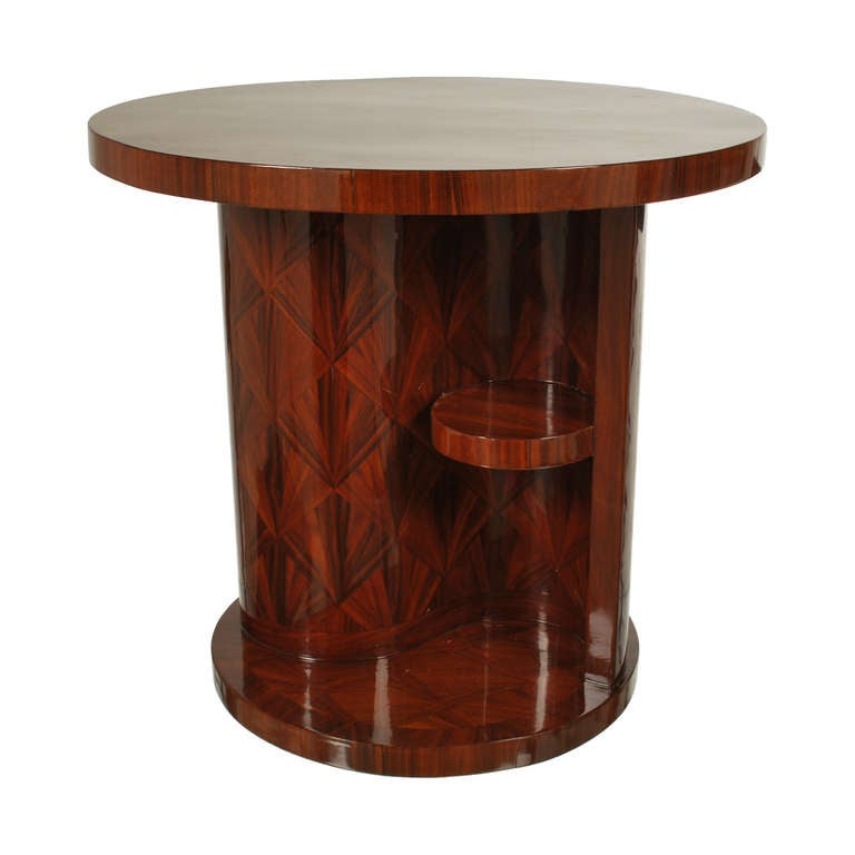 This stunning Art Deco style table in Rosewood, has a lovely fan-shaped marquetry pattern that covers the table top, pillar and base. The rich color, beautiful grain and high gloss finish, make this a dramatic piece of furniture. The S shaped pillar