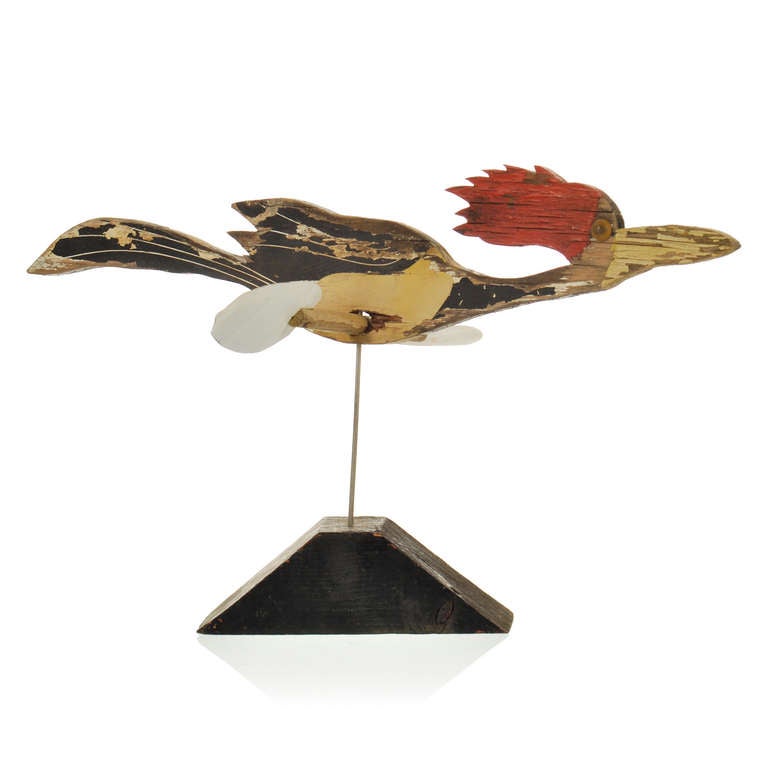 This is a wonderful folk art whirligig weathervane of a flying woodpecker on a nice primitive wood stand. Nice large size with faded and peeling paint and metal wings. The wire stand keeps the wings from spinning.

SHIPPING: For additional