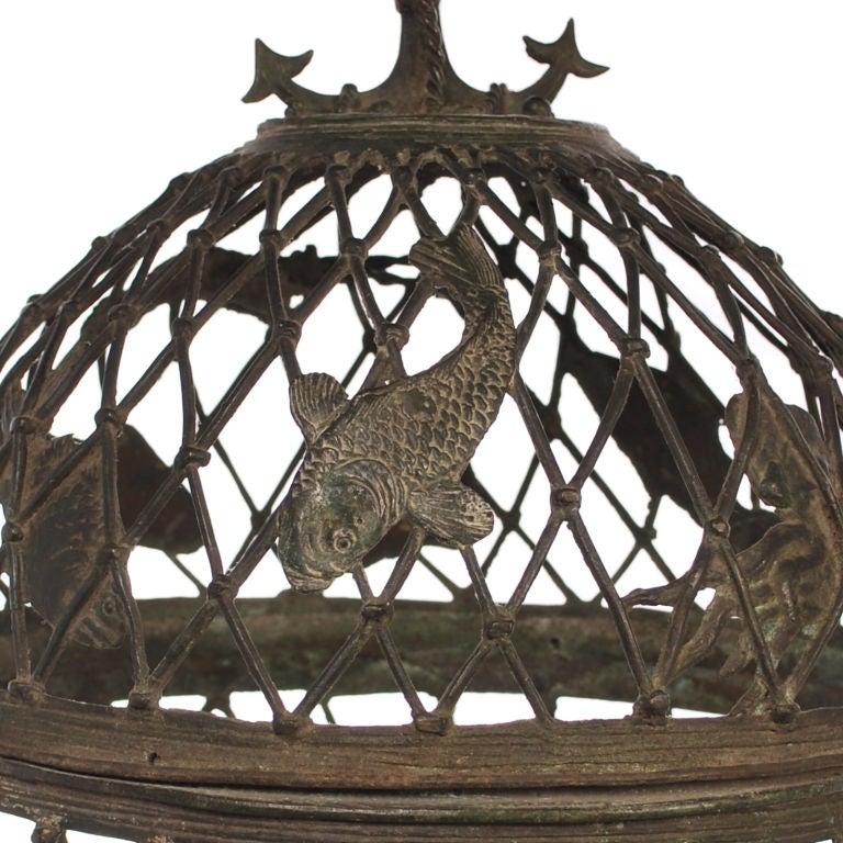 This is a fabulous Japanese bronze lantern covered with sea creatures. There are Sting Rays, Lobsters, Octopus, Koi and other variety's of fish, all in wonderful detail. The top of the lantern has a large boat anchor with chain for a hanger. The