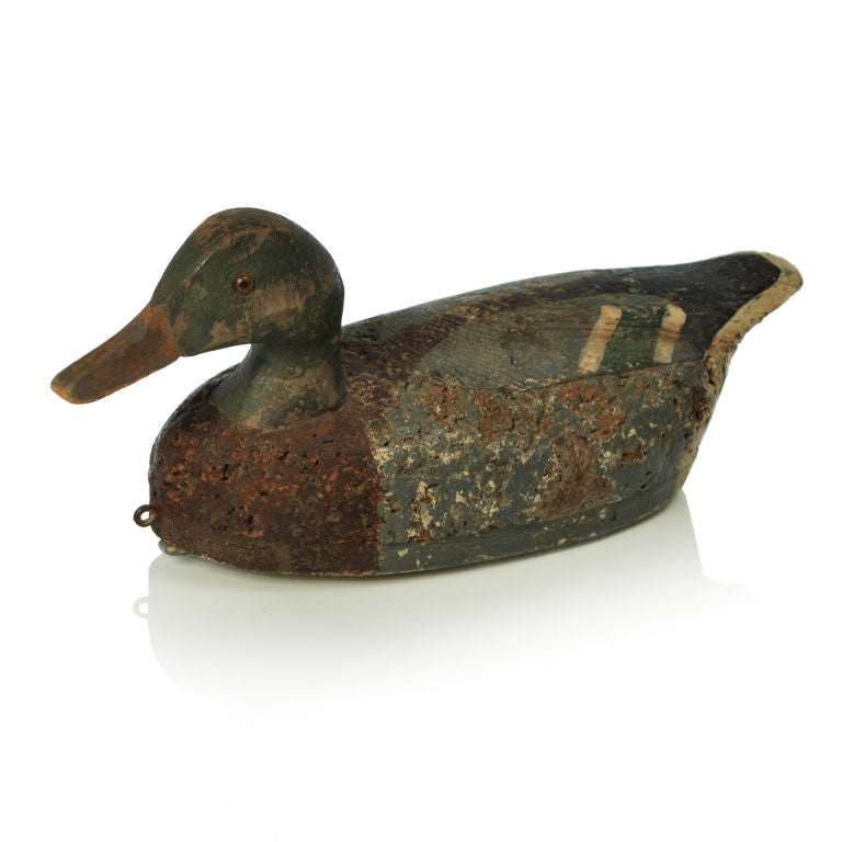 Very nice antique Mallard decoy with glass eyes. The decoy has a wood head, feathers and base with a cork body. There is a large strip of lead weight that runs the length of the body.